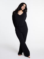 Woman in midnighties tuxedo set in color Midnight