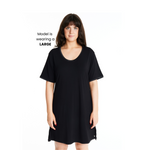 A woman wearing a short-sleeved, scoop-neck, knee-length nightie in a solid color, with satin trim detailing.
