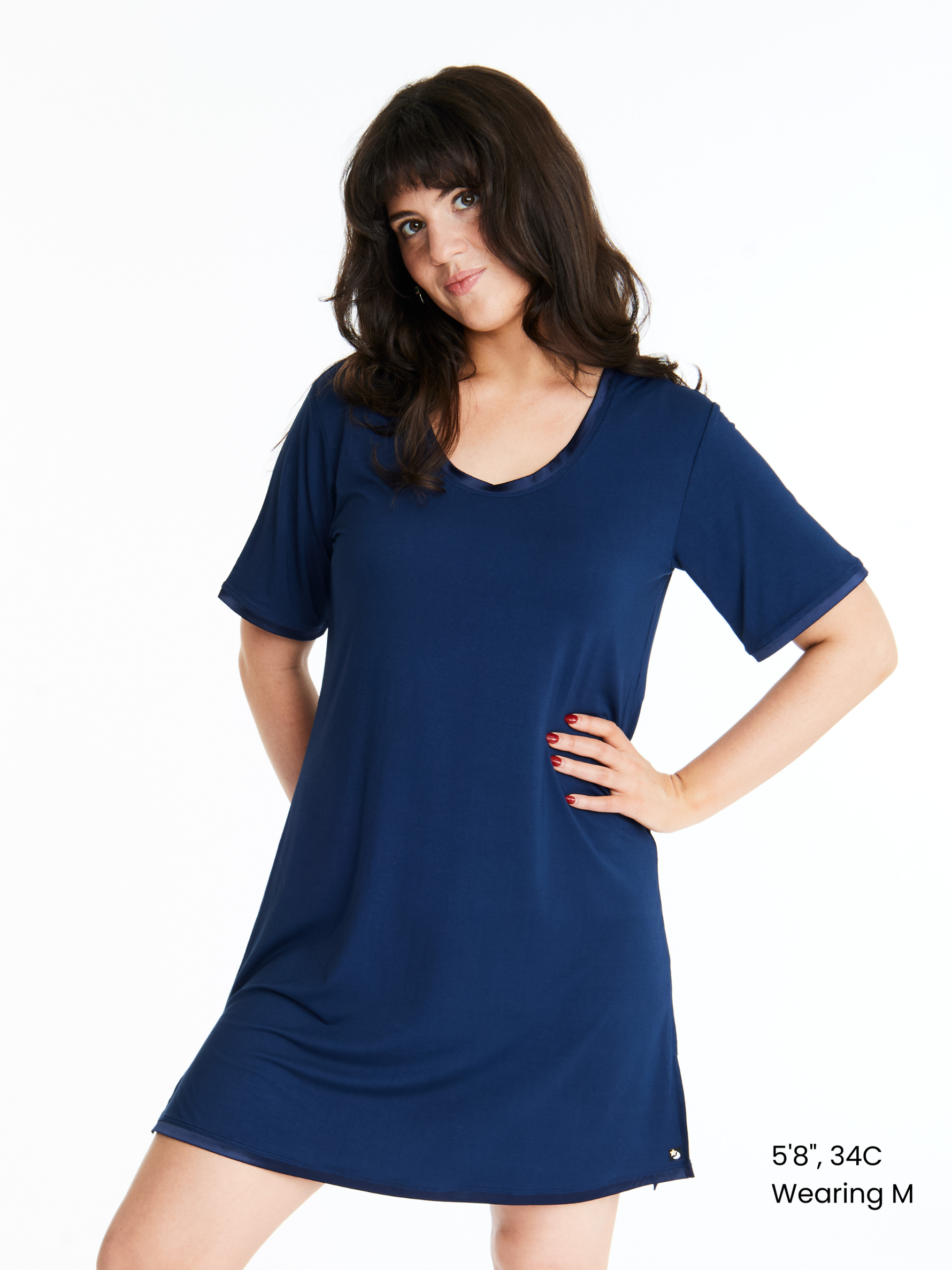A woman wearing a short-sleeved, scoop-neck, knee-length nightie in a solid color, with satin trim detailing.